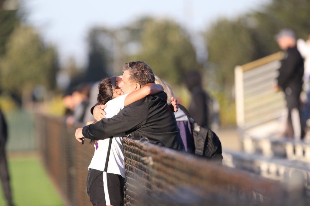 SF State midfielder Spenser Jaye (21) hugs her father Jeff Jaye at the end of the match against Holy Names University Hawks at the Skyline soccer field in San Bruno on Sept. 19, 2018. (Oscar Rendon/Golden Gate Xpress)