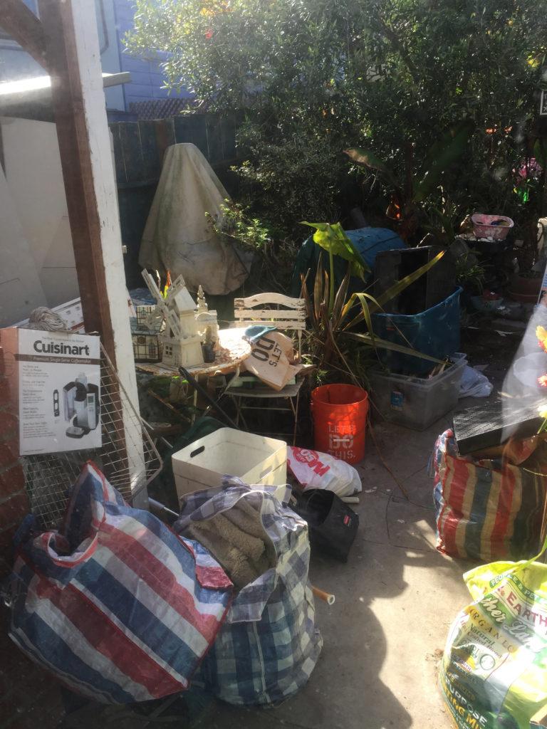 Trash and garbage is piled up in the backyard of a home due to hoarding all throughout the house causing flies and rats to swarm the area. (Megan Fitzmorris/Golden Gate Xpress)