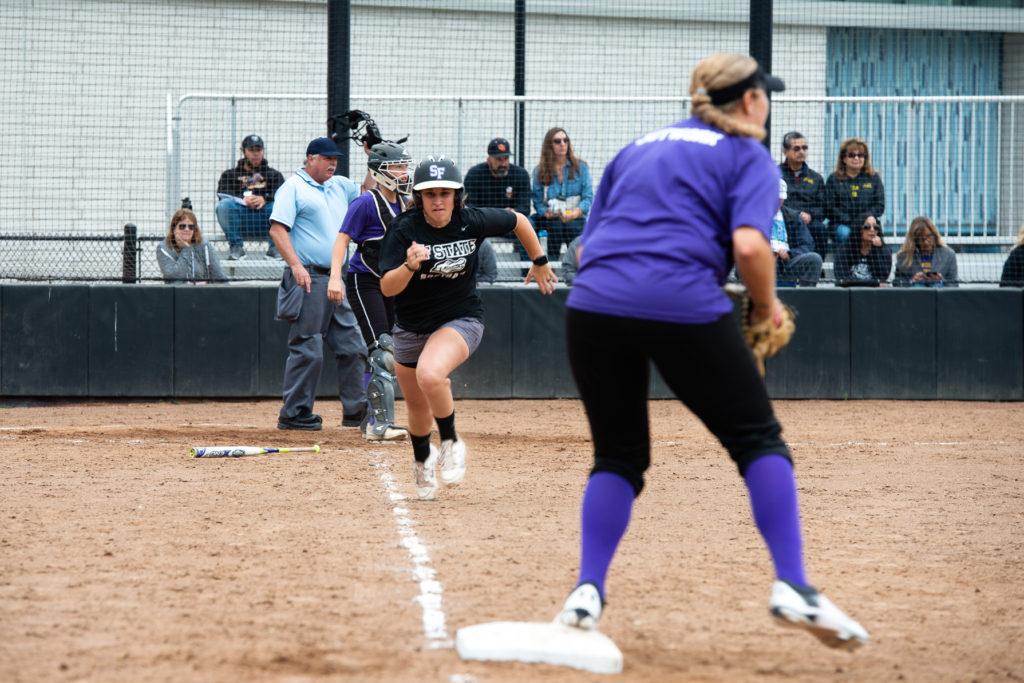 SF State alumna Jennifer Lewis runs to first base during the annual softball alumni game at the Softball Field on Saturday, Oct. 13. (David Rodriguez/Golden Gate Xpress)