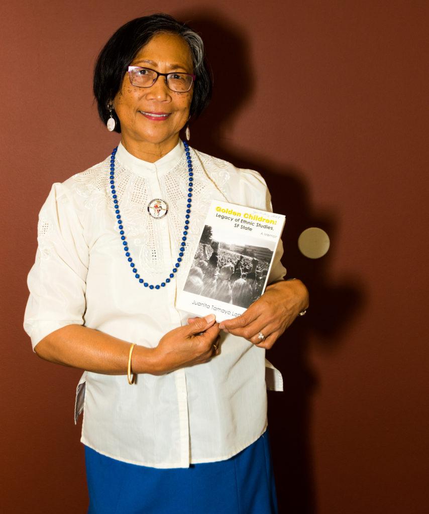 One of the strikers of the 1968-69 SF State student strike Juanita Tomayo Lott shows her latest book, “Golden Children: Legacy of Ethnic Studies, SF State,” at Towers Conference Center for the event to commemorate the 50th Anniversary of the SF State Student Strike at SF State on Saturday, Nov. 10, 2018.