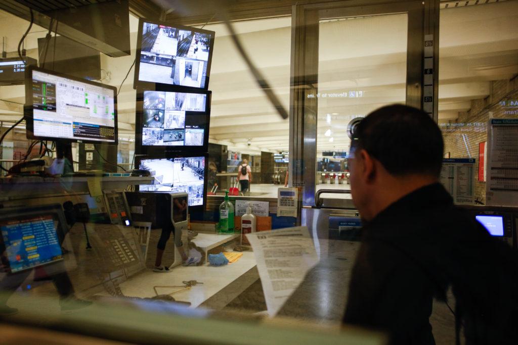 An BART operator, who refused to provide his name, reviews a document from one of the multiple control rooms at the Civic Center BART station while monitoring pick-up camera activity around the station on Sunday, Oct. 8, 2018. (Niko LaBarbera/Golden Gate Xpress)