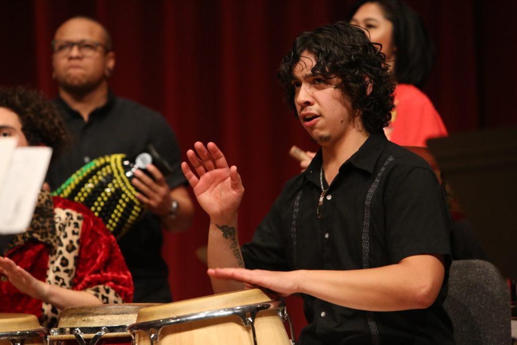 Ahkeel Mestayer-Velasquez plays the drums during the Afro-Cuban Jazz Ensemble Concert at SF State’s Knuth Hall on Wednesday, Dec. 5 2018. (Mira Laing/Golden Gate Xpress)
