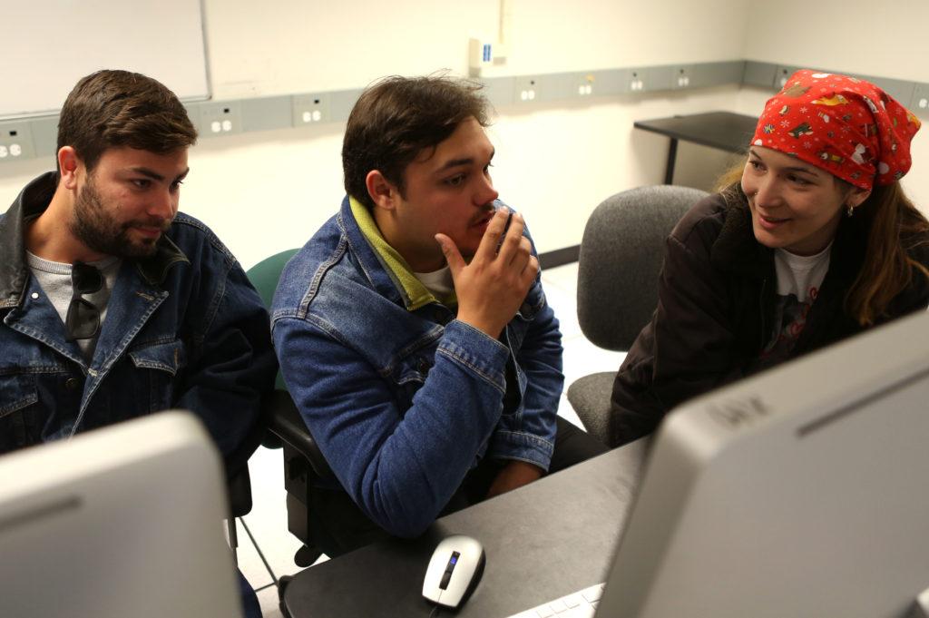 Producer Jeep Tatcher (left), director Jake Naso (center) and producer Maddy Graves (right) sit in one of the Cinema production labs while discussing the process of making their film Saguaro and the collaboration it took from their team on Tuesday, Dec. 4, 2018. (LINDSEY MOORE/Golden Gate Xpress)