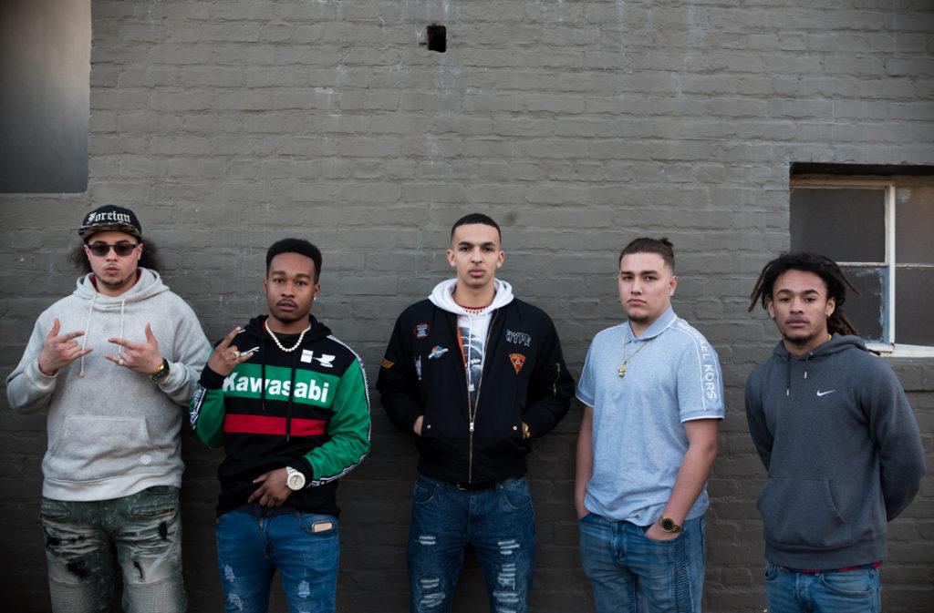 SF State biology major Isaiah Corona (far left), 19, political science major Kenneth Cason (left), 22, psychology major Jacob Shur (center), 19, Isaiah Price (right), 19 and Jordan Braithwaite (far right) form an student collective that collaborates on producing rap music. The group is getting ready to release a mixtape as well as individual musical projects as they balance the demands of school work and their passion for music. (Chris Robledo/Golden Gate Xpress)