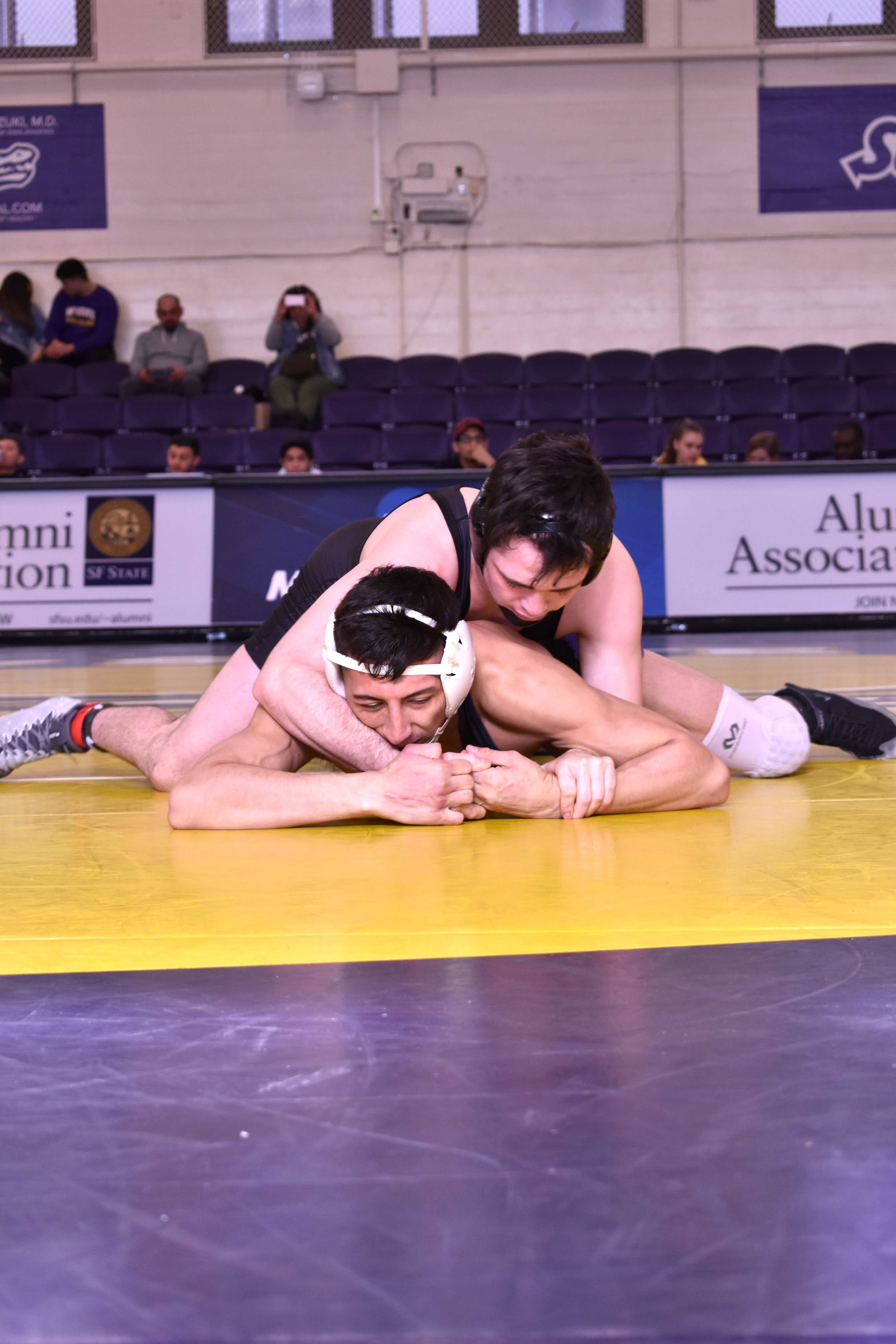 A player from the New Mexico Highlands wrestles with Isiah Alva in the Swamp at SF State in on Friday, Jan. 25.