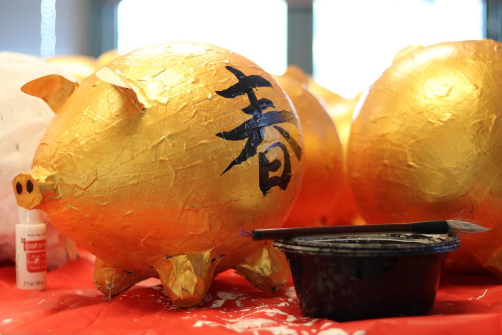 One of the golden papier-mache pigs thats being used as a table center piece for the Chinese New Year Celebration in the humanities building on Feb. 20, 2019.