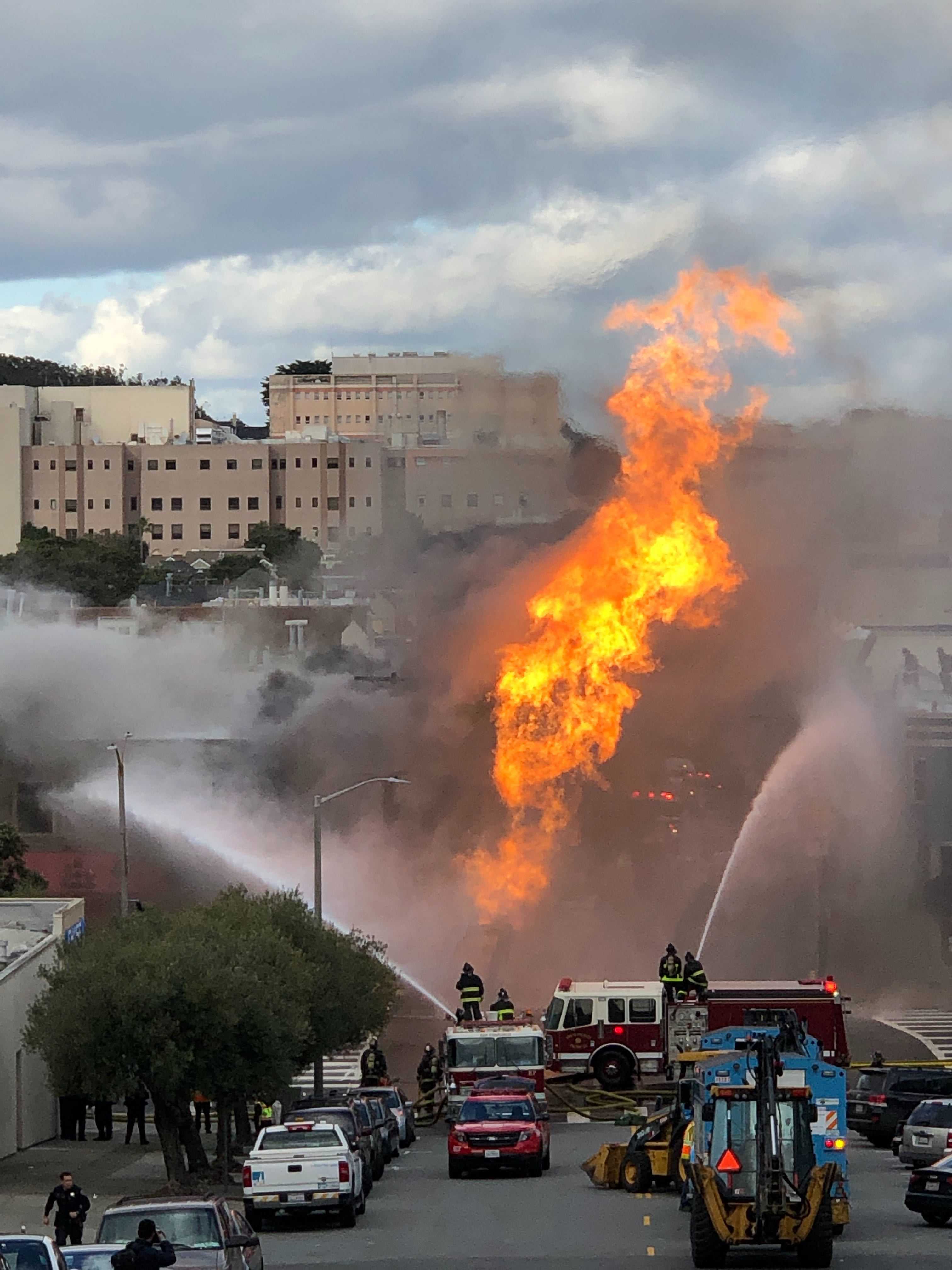 Firefighters spray water to contain the 3-alarm blaze on Parker Avenue and Geary Boulevard in San Francisco’s Richmond District on Feb. 6, 2019. (Chris Robledo/ Golden Gate Xpress) 