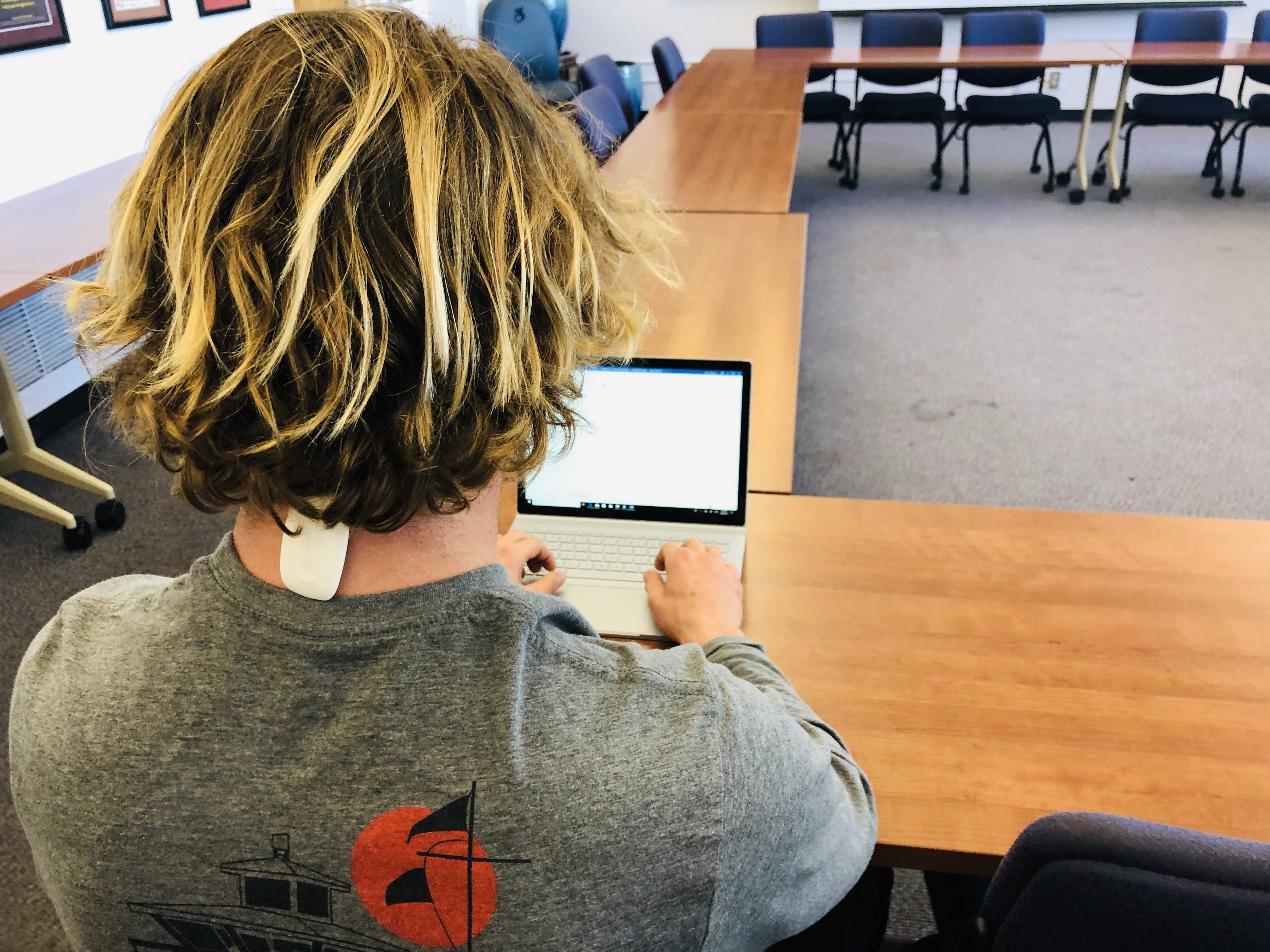 Economics major John Chetwynd wears the Upright GO device to monitor his posture while studying on March 5, 2019. (GEOFFREY SCOTT/ Golden Gate Xpress.)