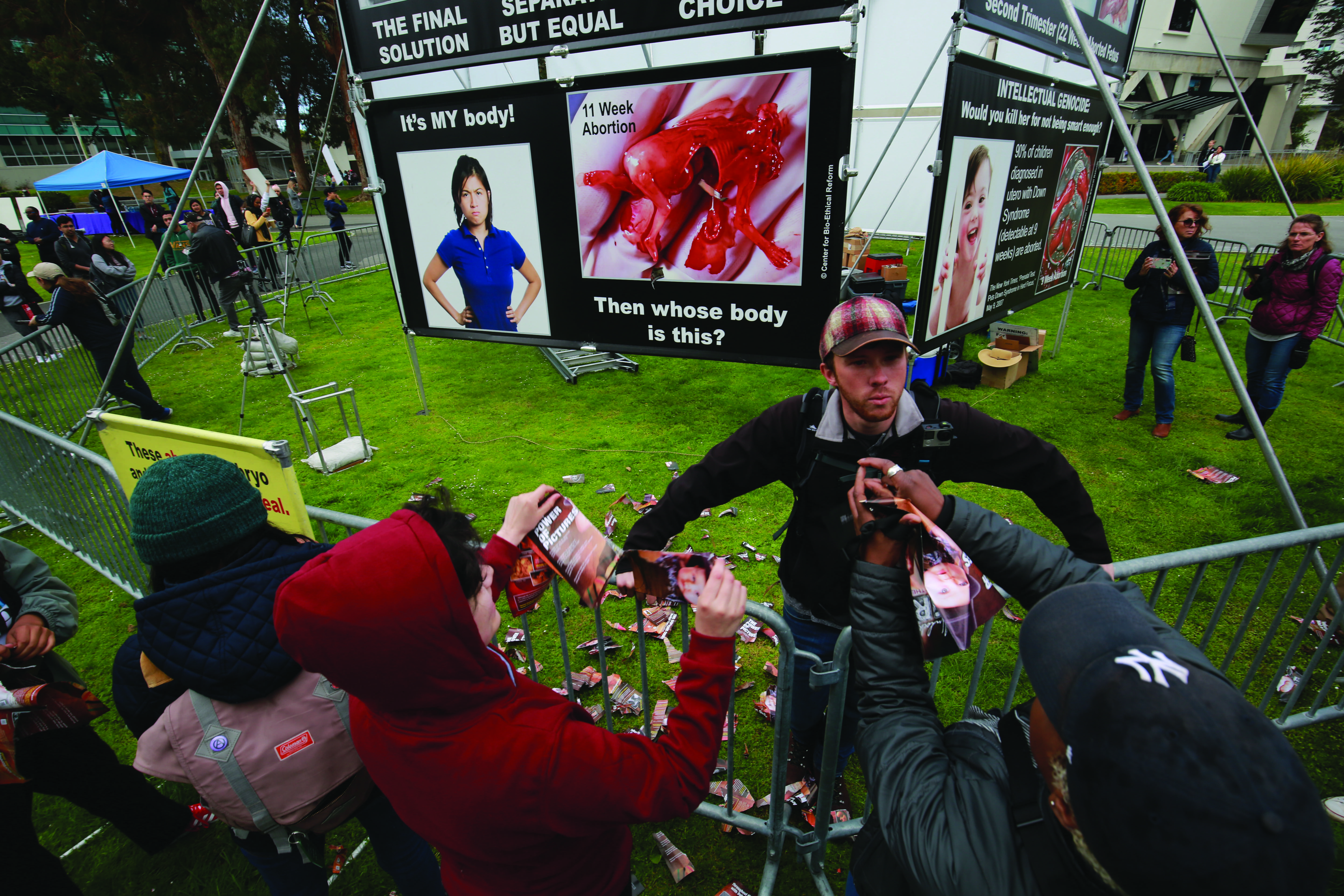 Matthew Vaughn argues with students as they tear up pamphlets during a demonstration in the quad by the organizations Project Truth, Genocide Awareness Project and Center for Bioethical Reform on  April 15, 2019. Vaughn first identified himself as John Newton. (JAMES CHAN/ Golden Gate Xpress)