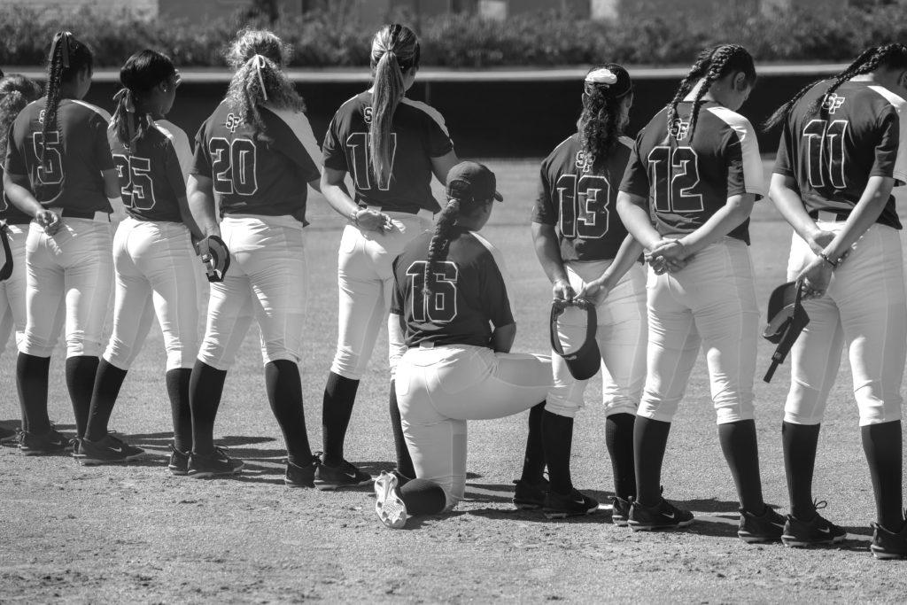 Tianna Jacques takes a knee during a softball game facing Academy of Arts on Thursday, April 18, 2019. (MADDISON OCTOBER/Golden Gate Xpress)