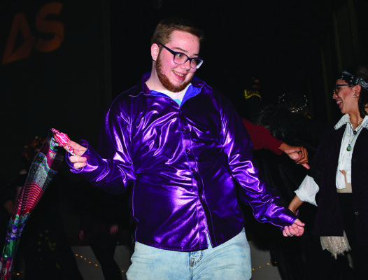 Donovan Devine, 20,  dances at the queer homecoming Saturday at Jack Adams hall in the Cesar Chavez building. (Photo by James Wyatt / Golden Gate Xpress)