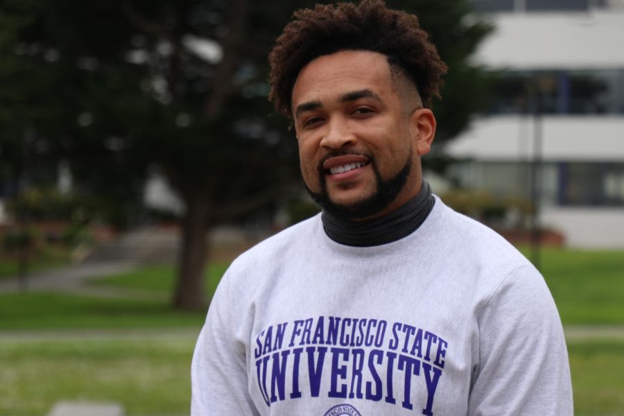 Sherrill poses for a portrait in Malcolm X Plaza sporting an SF State sweater. (Photo by Juan Carlos Lara/ Golden Gate Xpress)