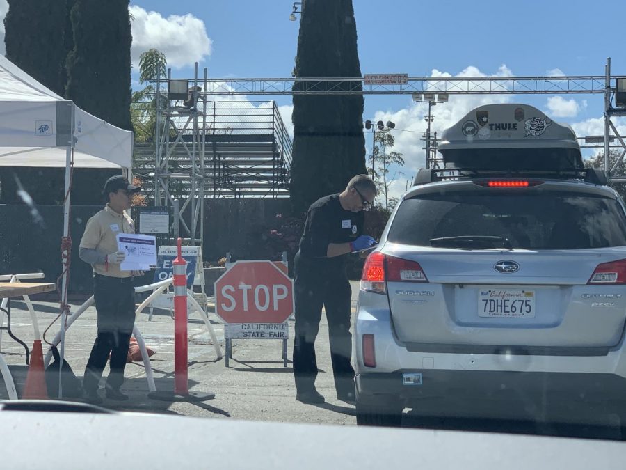 Medicare officials check cars for registration codes at Cal Expo in Sacramento. Free COVID-19 testing was supplied to people who took a consultation online before going to the testing location (Cierra Quintana / Golden Gate Xpress).