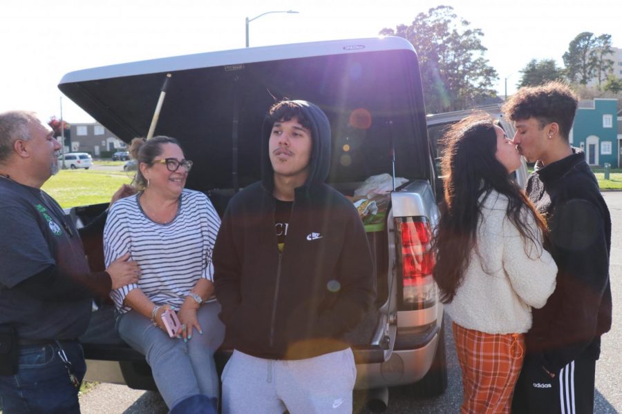 Raul Manzo kisses his girlfriend, Diana Rodriguez Calderon, goodbye before moving out while his parents and brother wait nearby.  (Juan Carlos Lara / Golden Gate Xpress)