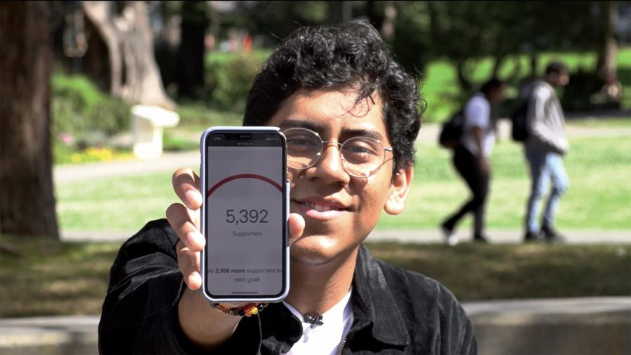 Lorenzo Ramos holds up his phone to show the number of signatures he had gathered via his online petition for SF State to cancel face to face classes in the wake of COVID-19. (David Sjostedt / Golden Gate Xpress).