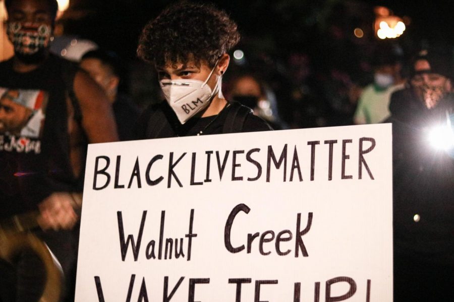 A protestor holds a placard that read BLACK LIVES MATTER Walnut Creek WAKE UP during the twilight protest in Walnut Creek, Calif., on Jun. 17, 2020 (Harika Maddala / Golden Gate Xpress)