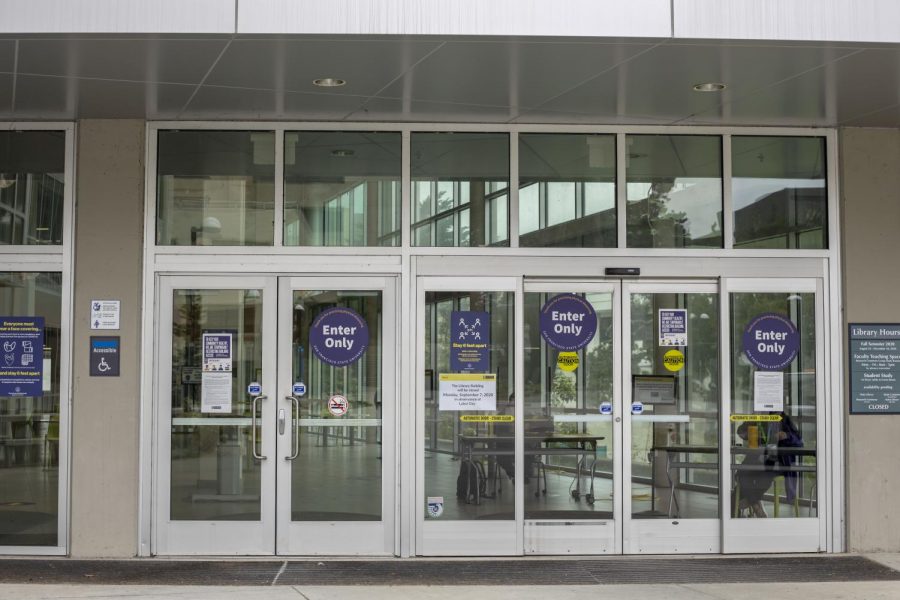 Exit-and enter-only signage are displayed on the doors of J. Paul Leonard Library at SF State.