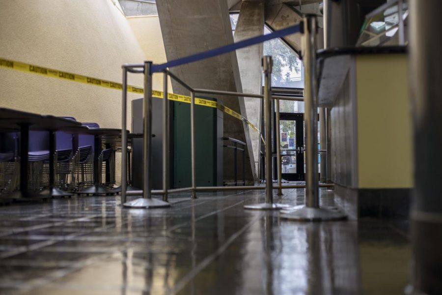 Caution tape surrounds chairs and tables around the student center to prevent people from dining indoors.
