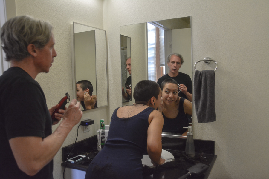 In their restroom at their new apartment in Oakland, shaylyn martos and her father shave her head together while quarantining for the COVID-19 crisis. (shaylyn martos/Golden Gate Xpress)