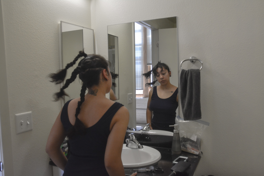 First, martos braided her long hair in three sections, which her father cut off with scissors. Before shaving her head, martos’ hair was about 18 inches long, reaching down her back. (shaylyn martos/Golden Gate Xpress)