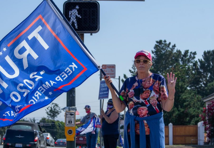 Trump supporter Nancy A. poses with four fingers up representing “four more years”, a common Trump slogan, on Sunday Sep. 27, 2020. (Jess Magill / Xpress Media)