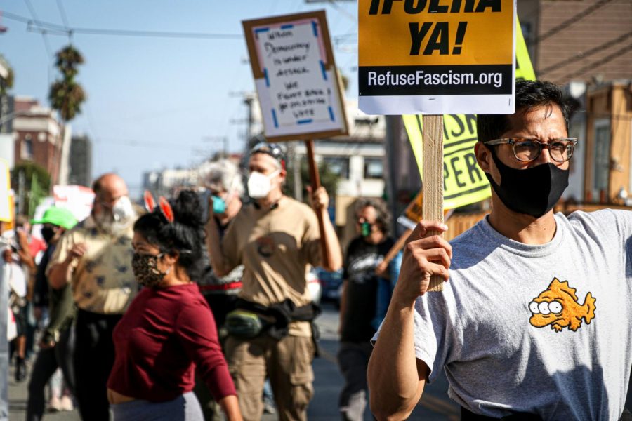 People march down 16th St. while chanting slogans asking people to vote for democracyin San Francisco on Oct. 24, 2020. The march was a collaboration among many Bay Area organizations such as March for Democracy SF, Refuse Fascism, Occupy San Francisco, etc. (Harika Maddala/ Golden Gate Xpress)