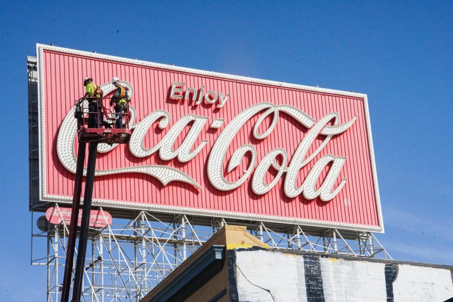 Workers begin to take down the Coca-Cola billboard, which has been there since 1937, near Interstate 80 and Highway 101 in downtown San Francisco on Oct. 26, 2020. San Francisco has issued a work permit to tear down the iconic structure. (Ricardo Olivares / Golden Gate Xpress)