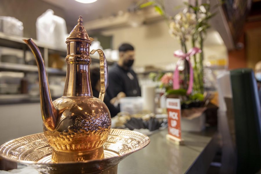 A copper tea kettle sits on a copper tray at the front desk register at Abu Salim Middle Eastern Grill on Haight Street in San Francisco, on Nov. 7, 2020. (Emily Curiel / Golden Gate Xpress)