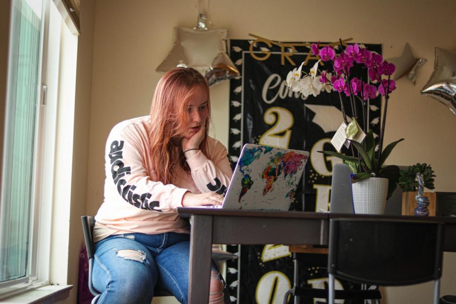 Hannah Khorassani reads about COVID-19 symptoms on her laptop, at her residence in Daly City, Calif., on July 19, 2020. Khorassani’s mother, who lives in Los Angeles, recently tested positive for COVID-19. (Harika Maddala / Golden Gate Xpress) 
