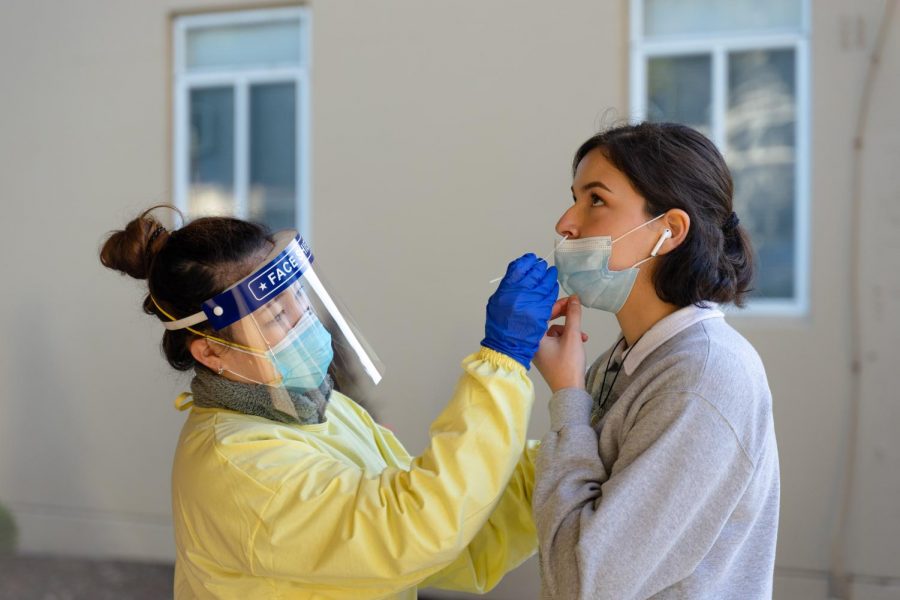 Jessica Garzaro receives a nasal swab COVID-19 test as a mandatory requirement for students living on campus on Friday at the University Park North testing site. (Jun Ueda / Golden Gate Xpress)