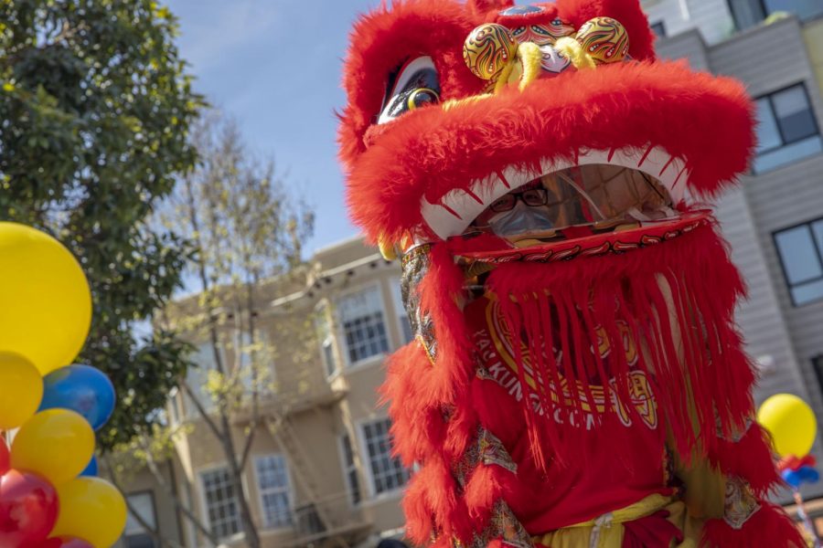 Yau Kung Moon lion dance crew performs for a crowd of people who gathered at the Asian Community Support Event on Sunday, April 11, 2021, at 701 Valencia St., in the Mission District. (Emily Curiel / Golden Gate Xpress)