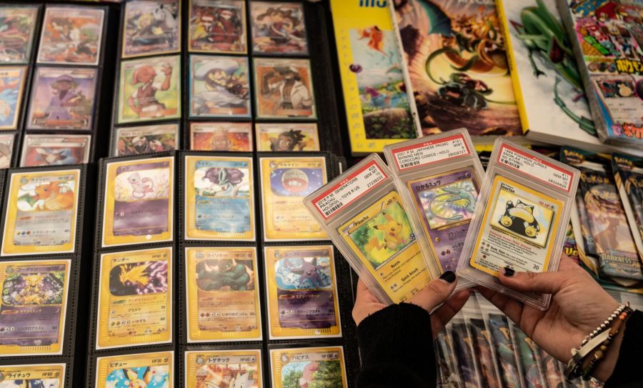 Gallegos holds three of many sealed Pokemon cards that she collects along with binders filled with cards that are completely in Japanese in Berkeley, Calif., on April 16. When she was 18 years old, she started to seriously collect Pokemon cards after buying a pack from Target. (Samantha Laurey / Golden Gate Xpress) 
