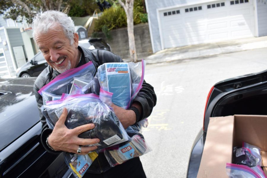 Founder of Blanket The Homeless, Ken Newman, loads his car with kits for people experiencing homelessness in San Francisco. Kits are filled with items like Cliff bars, socks, silver thermal blankets, masks, and a waterproof resource guide. (Lucky Whitburn-Thomas / Golden Gate Xpress)