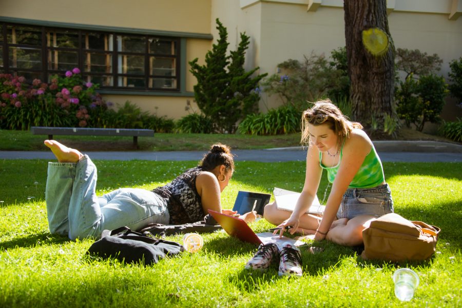Esperanza and Rose (L to R) spend time in the sun doing homework in San Francisco State University’s Garden of Remembrance on Sept. 20, 2021. (Garrett Isley/Golden Gate Xpress)