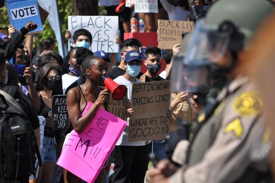 Former Cal Poly Pomona student Timisola Ogunleye participates in crowd chanting at the intersection of Diamond Bar Boulevard and Grand Avenue on June 4, 2020, in Diamond Bar, Calif. She said the true form of protesting is causing civil disobedience to be heard, and urges others to pace themselves when protesting and performing activist work. (Chris Ramirez / Golden Gate Xpress)