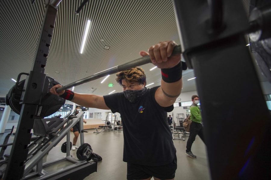 Jacob Magpantay prepares to back squat 435 lb inside the weight training area of the Mashouf Wellness Center at SF State in San Francisco on Sep. 14, 2021. (Nicolas Cholula / Golden Gate Xpress)