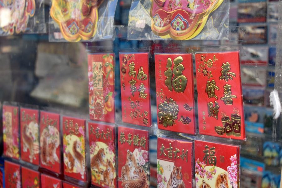 Red envelopes are taped on a storefront window in Chinatown on Feb. 1, 2022. (Karina Patel / Golden Gate Xpress)