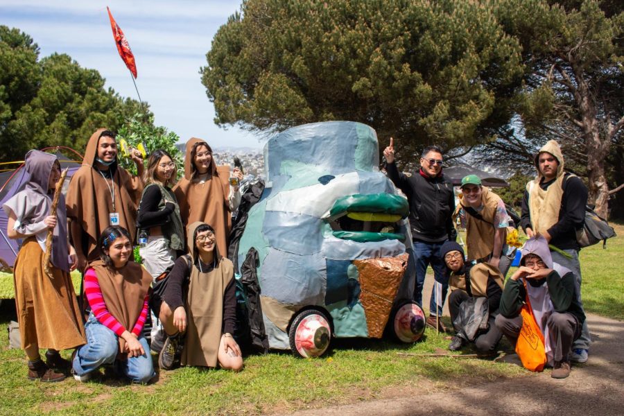 SF State Associate Art Professor Michael Arcega and students from his Sculpture and Expanded Practices class pose with their Frankenstein-inspired soapbox, “Mary’s Monster.” (Myron Caringal / Golden Gate Xpress)