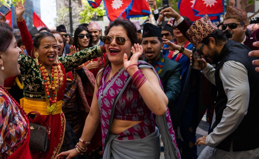 Paradegoers dance to traditional music while marching on Market Street Saturday. (Rashik Adhikari / Golden Gate Xpress)