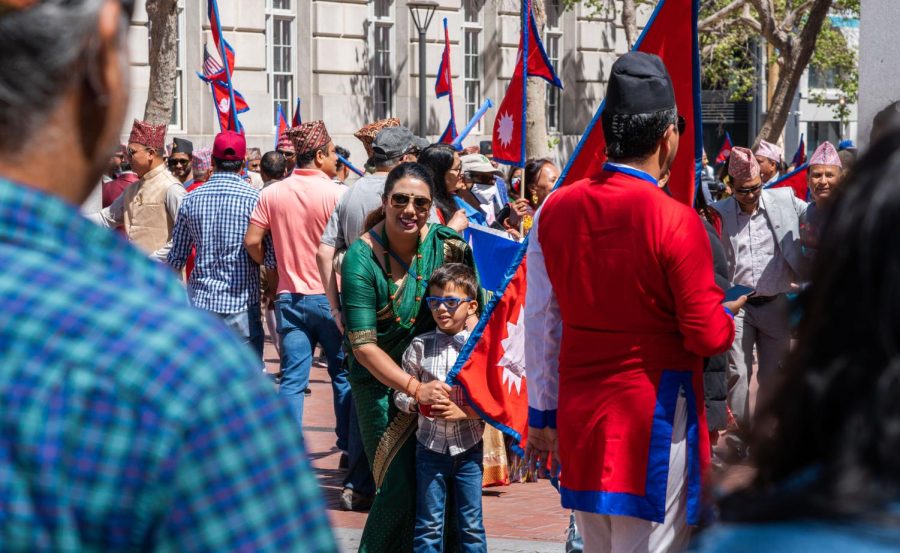 A mother helps her son hold a Nepalese flag while posing for a photo at UN Plaza on Saturday.
(Rashik Adhikari / Golden Gate Xpress)