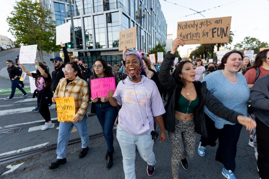 Protesters against the overturning of Roe v. Wade walk on Market Street on May 3. (Abraham Fuentes / Golden Gate Xpress)