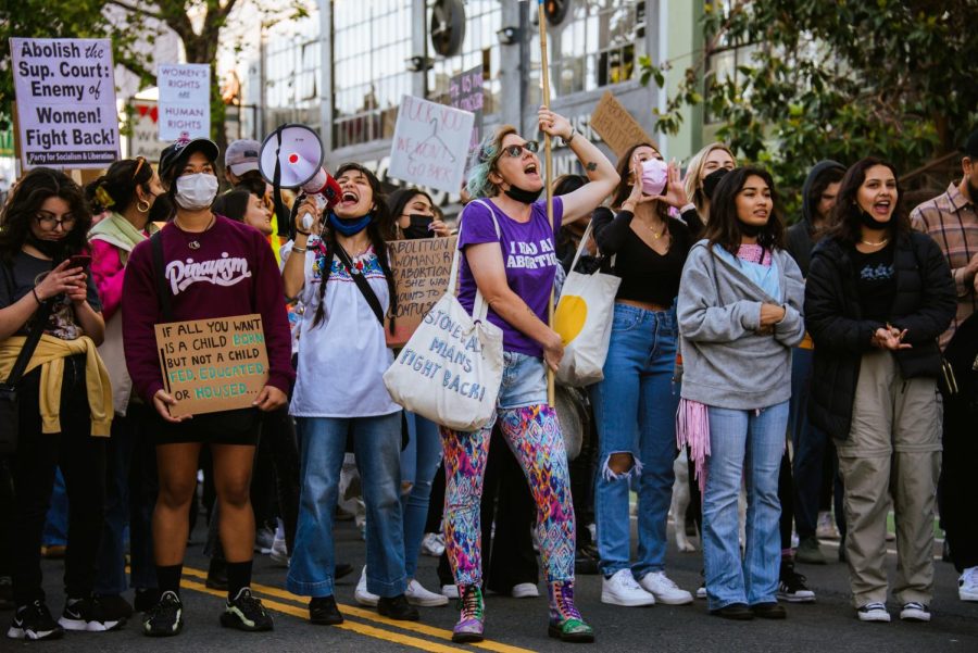 Nayelli Zechman and Nathalie Hrizi lead the protest down Market Street in San Francisco on Tuesday in opposition to the Supreme Court’s draft opinion to overturn Roe v. Wade. (Garrett Isley / Golden Gate Xpress)