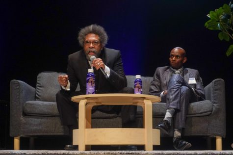 Cornel West (left) and Abul Pitre sit on stage in the McKenna Theatre at SF State. West led a panel discussion with SF State faculty about liberation and social justice on Sept. 29, 2022. (Neal Wong / Golden Gate Xpress)
