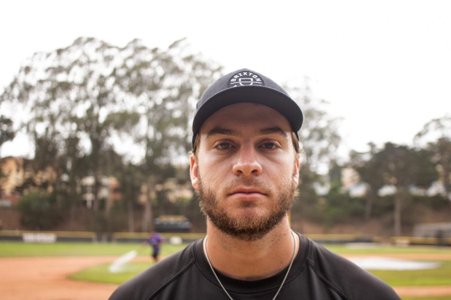 Jensen poses for a portrait on Sept. 10 in front of the baseball field at SF State, where he recorded his first strikeout after a spinal fusion surgery. (Oliver Michelsen / Golden Gate Xpress)