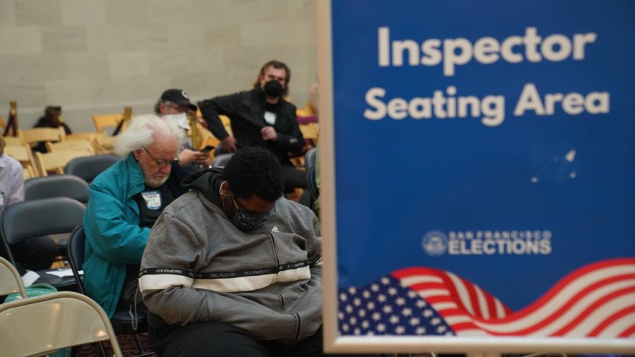 Voting station Inspectors, who are responsible for overseeing the security of polling stations, sleep while awaiting their duty at San Francisco’s Capitol building on Nov. 8, 2022. The inspectors had to be at city hall by 6 a.m., but had the potential to stay there until 10 p.m. (Joshua Carter / Golden Gate Xpress)