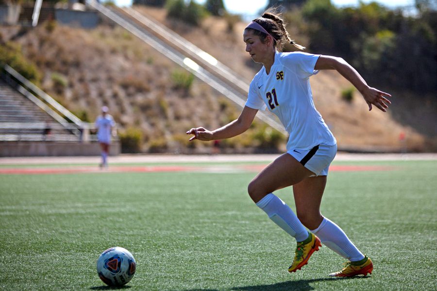 SF State Womens Soccer midfielder Julia Hagedorn dribbles the ball against Cal State East Bay at Pioneer Stadium in Hayward, CA on Sept. 2, 2022. (Jesus Arriaga for Golden Gate Xpress)