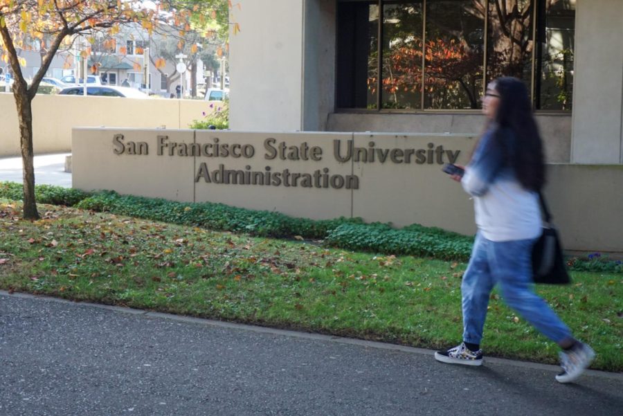 A student walks past the Administration Building at SF State on Dec. 7, 2022. (Tatyana Ekmekjian / Golden Gate Xpress)