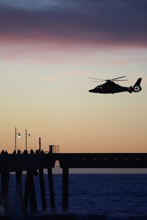 A coast guard patrol helicopter flies overhead near Sharp Beach in Pacifica, Calif. on Jan. 19, 2023. The helicopter has been looking for an SF State student who went missing around 10:30 and was still searching as of 6 p.m. (Joshua Carter / Golden Gate Xpress)
