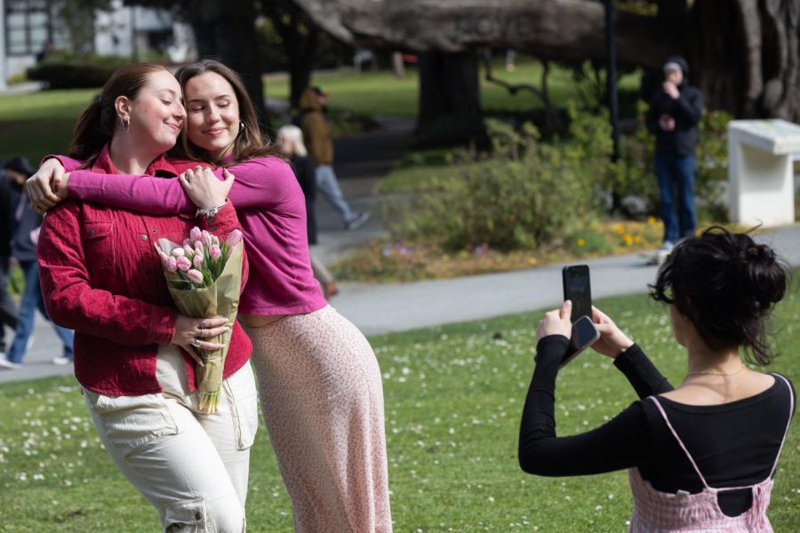 Fay Harris (R) takes a photo of Jade Lollis (L) and Rebecca Kirkland at SF State’s Quad on Valentines Day on Tuesday, Feb. 14, 2023. (Benjamin Fanjoy / Golden Gate Xpress)