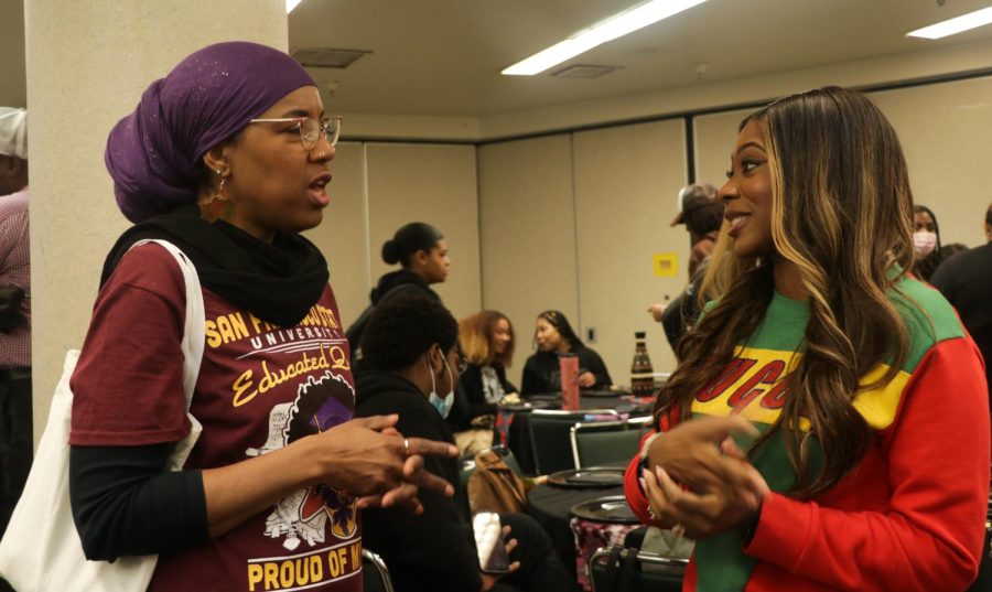 Jamila Ali (L) and Shanice Robinson (R)  talk during the Chicken and Juice event at SF State’s Cesar Chavez Student Center on Friday, Feb. 23, 2023. Robinson says it’s an event that allows Black faculty and staff to introduce themselves to students and be in a safe space amongst their community. (Gina Castro / Golden Gate Xpress)